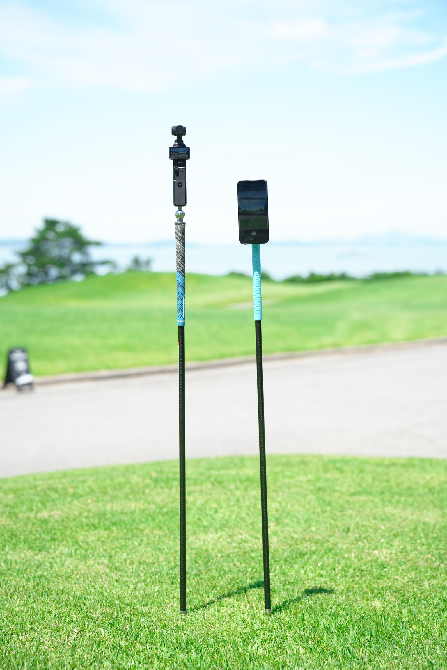 Outdoor filming mode — two Swingpods with spike in turf, DJI Osmo Pocket and phone